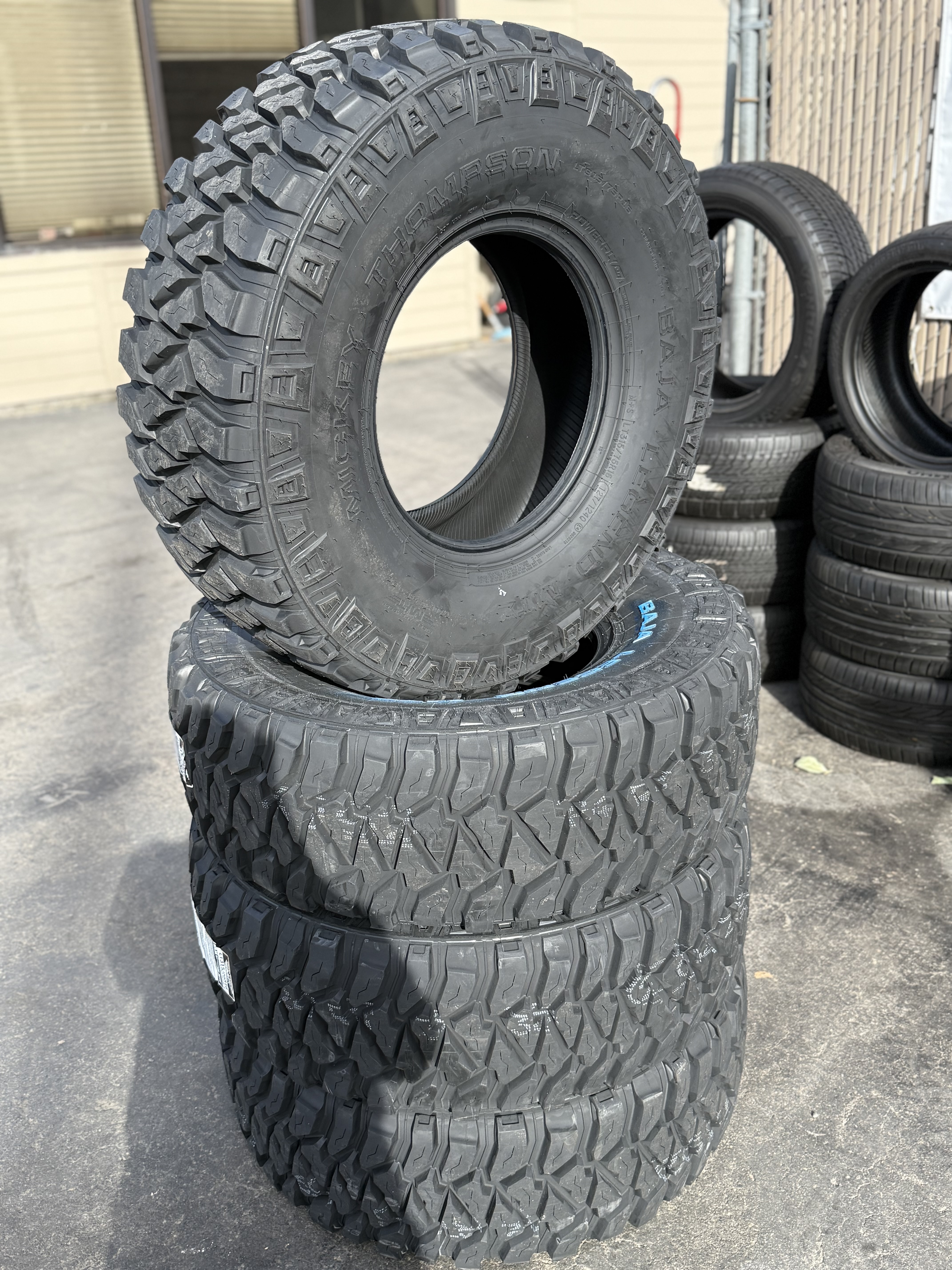 aggressive off-road tire stack displayed at MC Wheels and Tires