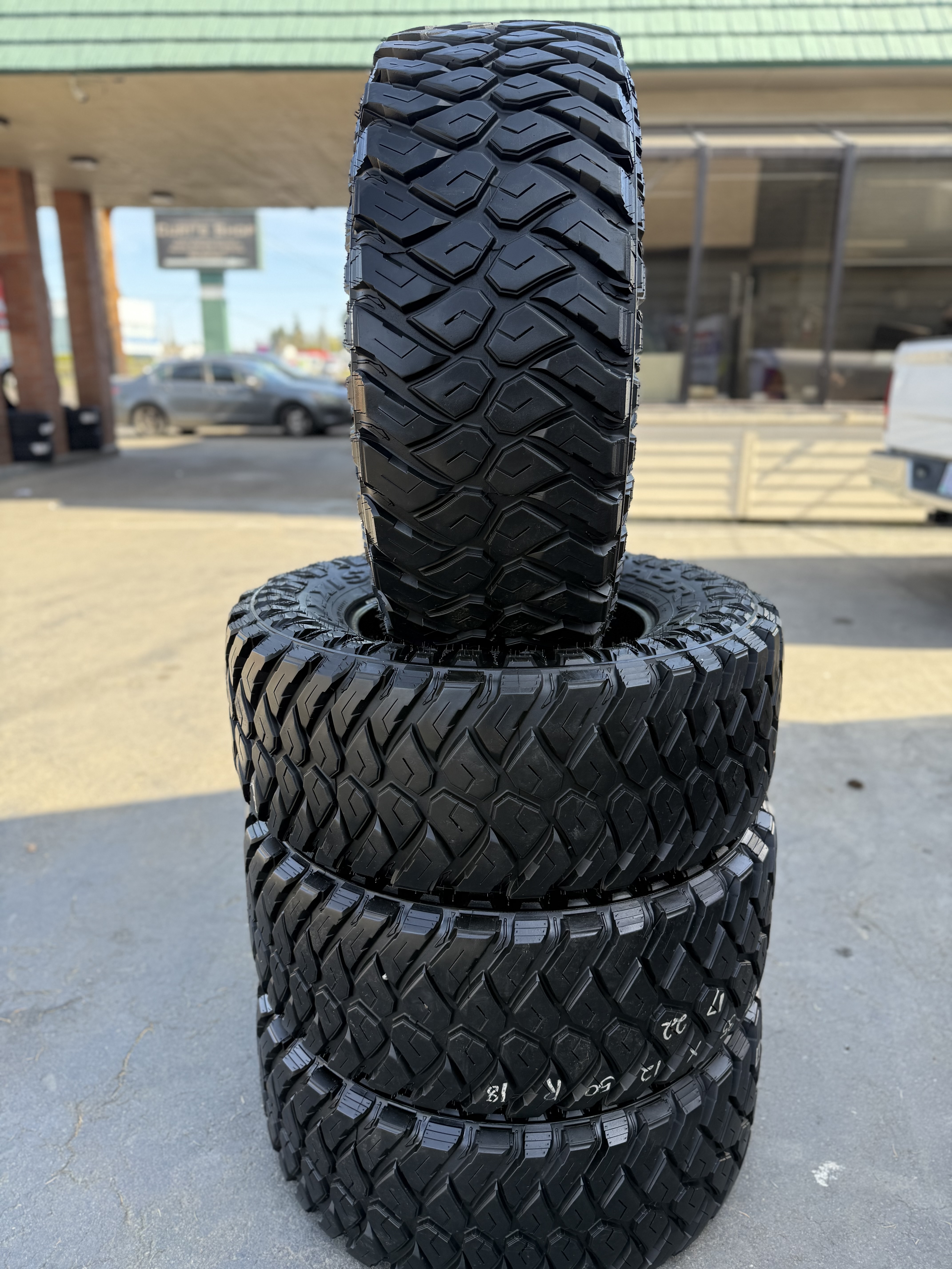 stack of off-road tires outside the shop at MC Wheels and Tires